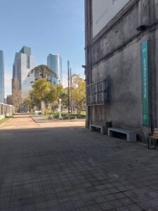 Acceso al Museo de la Inmigración en Buenos Aires, ubicado en el antiguo Hotel de Inmigrantes, con la vereda y los edificios modernos de Puerto Madero de fondo